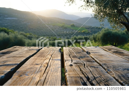 Empty old wooden table for product display with natural green olive field and green olives 110505981