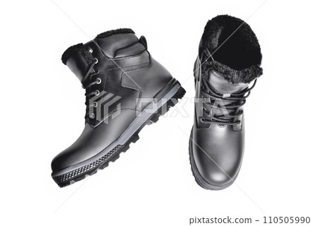 Winter black leather boots on a white background, hiking shoes, practical off-road shoes, close-up Winter black leather boots on a white background, hiking shoes, practical off-road shoes, close-up 110505990
