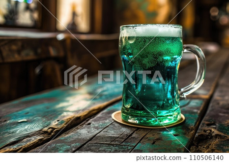 A glass of green beer on a table in a pub. St Patrick's day, holidays and celebration concept A glass of green beer on a table in a pub. St Patrick's day, holidays and celebration concept 110506140