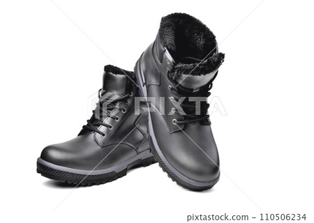 Winter  black leather boots on a white background, hiking shoes, practical off-road shoes, close-up 110506234