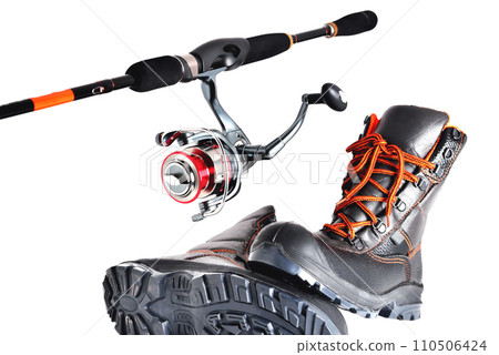 Spinning with a reel and off-road shoes with orange laces on a white background, isolate 110506424