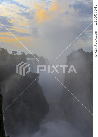 Morning fog over Victoria Falls in the Zambezi Gorge at sunrise. Morning fog over Victoria Falls in the Zambezi Gorge at sunrise. 110507543