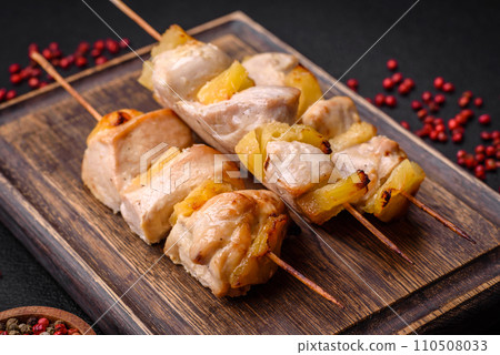 Delicious chicken or turkey kebab with pineapple pieces on skewers Delicious chicken or turkey kebab with pineapple pieces on skewers 110508033