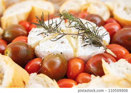 Camembert cheese baked with tomatoes and bruschetta. 110509806