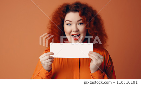 beautiful young redhead woman showing blank card isolated on orange background. 110510191