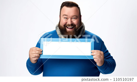 Cheerful bearded man holding a blue frame and looking at the camera. Portrait of a smiling bearded man in blue sweater and scarf holding a blank picture frame on white background. 110510197