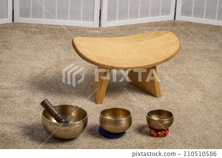 Tibetan singing bowls and meditation, kneeling bench to sit in a natural, balanced and relaxed posture 110510586