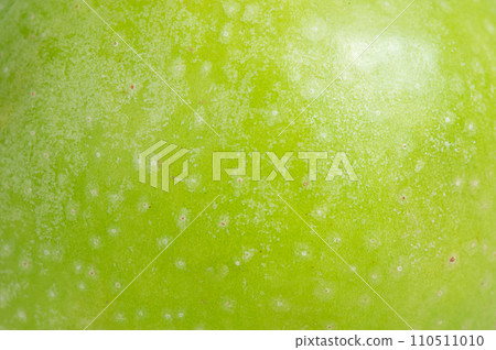 The texture of a delicious fresh apple as a background. Apple as a material for a designer. The texture of a delicious fresh apple as a background. Apple as a material for a designer. 110511010