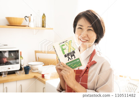Smiling woman reading an investment book 110511482