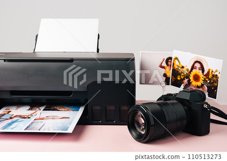 Printer and photo camera on table. Printing photos concept 110513273