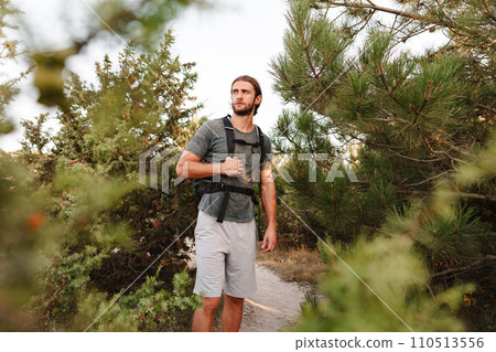 Portrait of hiker man with backpack trekking in the mountains Portrait of hiker man with backpack trekking in the mountains 110513556
