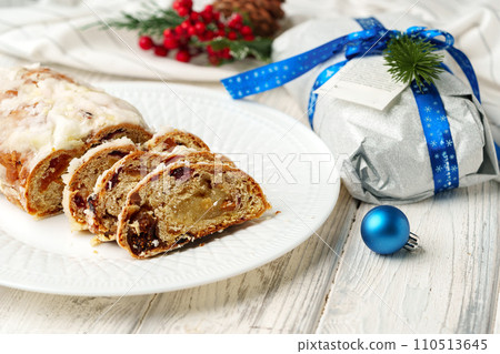 Christmas stollen on plate on white wooden table Christmas stollen on plate on white wooden table 110513645