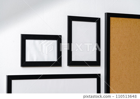 Set of black frames on white wall with copy space Set of black frames on white wall with copy space 110513648