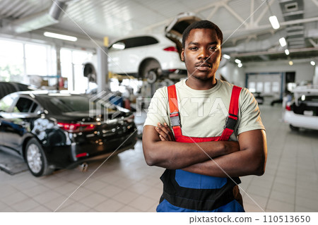 African man mechanic in uniform at the car repair station, portrait African man mechanic in uniform at the car repair station, portrait 110513650