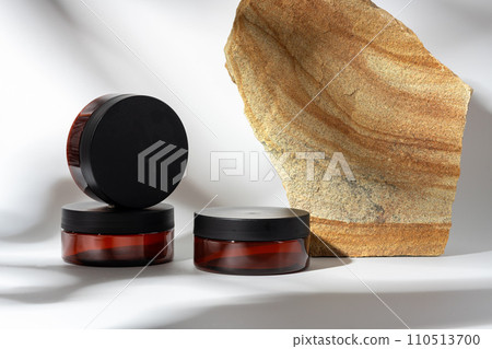 Cosmetic product jar in composition with granite stones and shadow 110513700