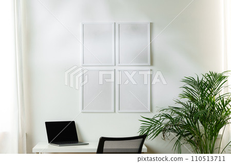 Empty frames on the wall above the working table in the office Empty frames on the wall above the working table in the office 110513711