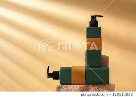 Cosmetic package dispenser with granite stone studio shot Cosmetic package dispenser with granite stone studio shot 110513828