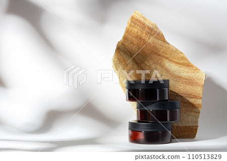 Cosmetic product jar in composition with granite stones and shadow Cosmetic product jar in composition with granite stones and shadow 110513829