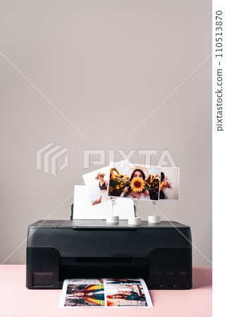 Modern laser printer printing color photos of women close up Modern laser printer printing color photos of women close up 110513870
