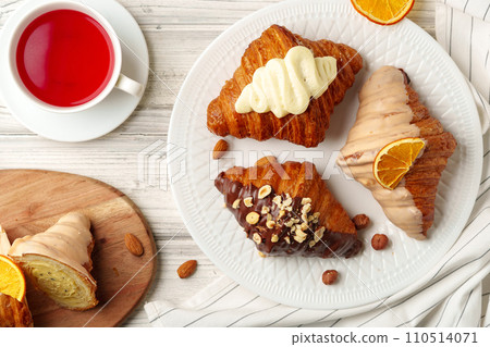 Fresh croissants with cup of tea on table Fresh croissants with cup of tea on table 110514071