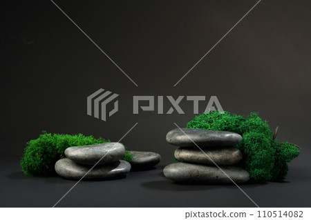 Stones decorated with green moss against black background 110514082