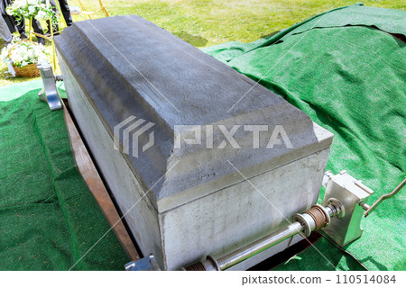 Funeral service with coffin of deceased during ceremony 110514084