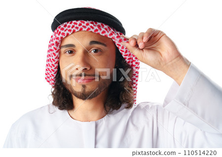 Portrait of a young Arab man wearing middle-eastern traditional dress thobe isolated on white Portrait of a young Arab man wearing middle-eastern traditional dress thobe isolated on white 110514220