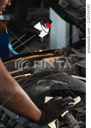 Close up of hands of auto mechanic working in a garage 110514345