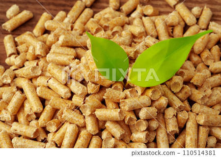 Heap of wooden pellets biofuel on wooden table Heap of wooden pellets biofuel on wooden table 110514381