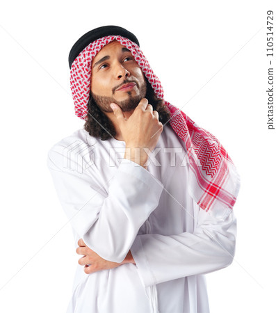 Pensive young man in traditional middle-east dress thobe on white background Pensive young man in traditional middle-east dress thobe on white background 110514729