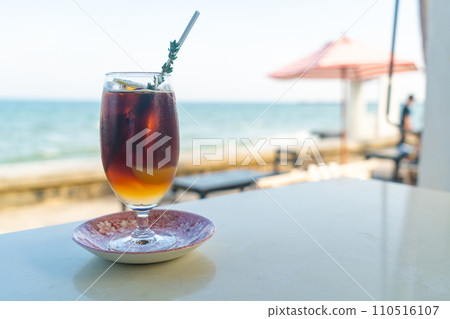 iced americano coffee peach with sea background 110516107