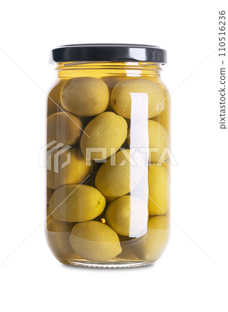 Green olives with pit, pickled whole, large Greek table olives, in a glass jar with screw cap. Whole fruits, picked when they are still unripe and of bitter taste, preserved in a brine. Front view. 110516236