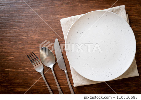 empty plate or dish with knife, fork and spoon empty plate or dish with knife, fork and spoon 110516685