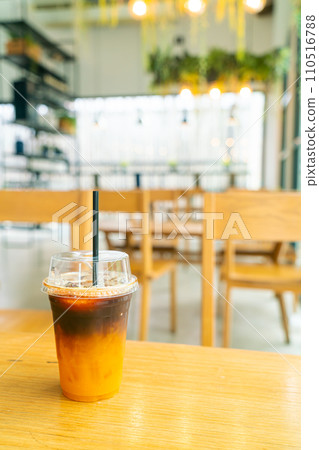 iced black coffee with yuzu cup on table iced black coffee with yuzu cup on table 110516788