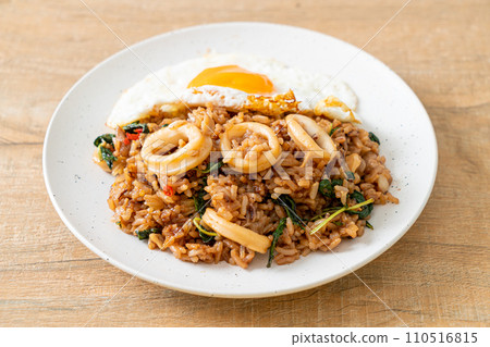 fried rice with squid and basil topped fried egg in Thai style fried rice with squid and basil topped fried egg in Thai style 110516815
