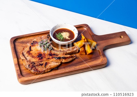 grilled pork chop steak with spicy jaew sauce 110516923