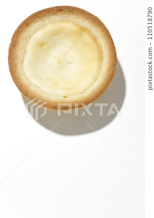 An overhead shot of a bite-sized cheese tart against a white background 110518790