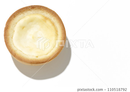 An overhead shot of a bite-sized cheese tart against a white background An overhead shot of a bite-sized cheese tart against a white background 110518792