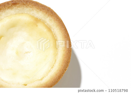 An overhead shot of a bite-sized cheese tart against a white background An overhead shot of a bite-sized cheese tart against a white background 110518798