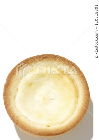 An overhead shot of a bite-sized cheese tart against a white background 110518801