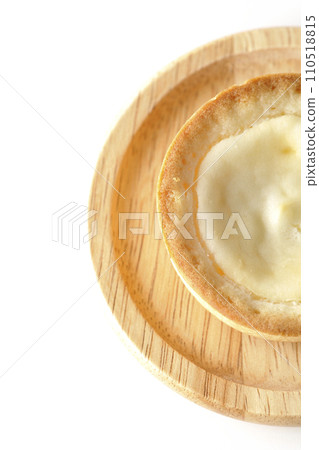 An overhead shot of a bite-sized cheese tart against a white background An overhead shot of a bite-sized cheese tart against a white background 110518815