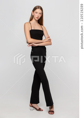 A beautiful blonde girl with a thin slender figure and long legs. A beautiful blonde girl with a thin slender figure and long legs. 110519289