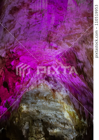 Karst cave, amazing view of stalactites and stalagnites in colorful bright light, beautiful natural Karst cave, amazing view of stalactites and stalagnites in colorful bright light, beautiful natural 110519953