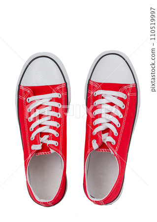 Red sneakers close-up on a white background, top view. Red sneakers close-up on a white background, top view. 110519997
