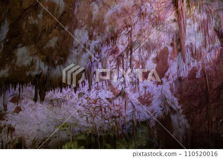 Karst cave, amazing view of stalactites and stalagnites in colorful bright light, beautiful natural landmark in touristic place. 110520016