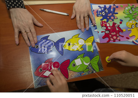 A psychologist conducts a psychological test for a child with mental retardation. A psychologist conducts a psychological test for a child with mental retardation. 110520051