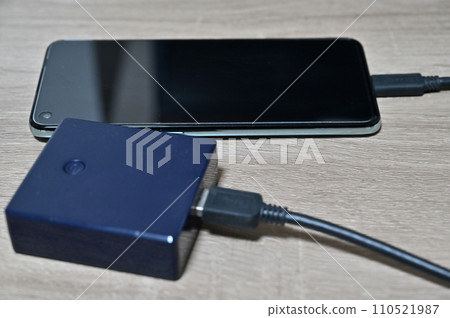 Charge your smartphone with a mobile battery Charge your smartphone with a mobile battery 110521987