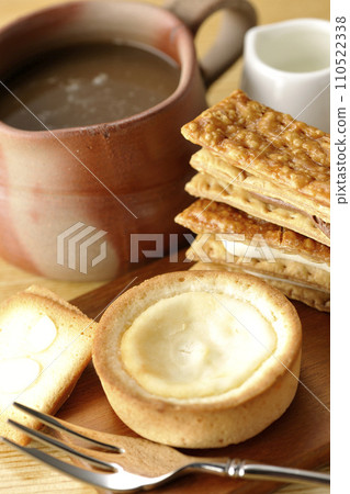Coffee time with cookies, cream sandwiches, cheese tarts, and various baked goods 110522338