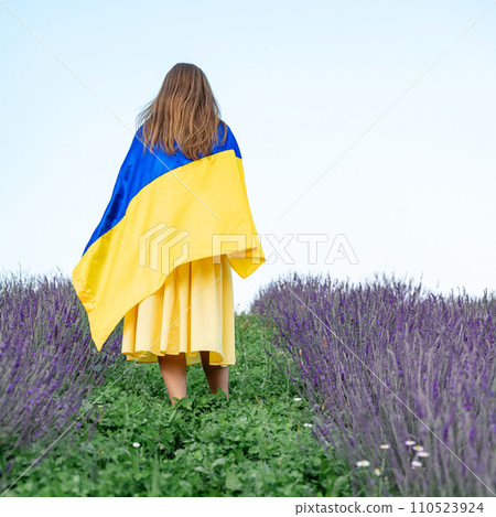 Ukrainian flag in the hands of a girl. Ukrainian flag in the hands of a girl. 110523924