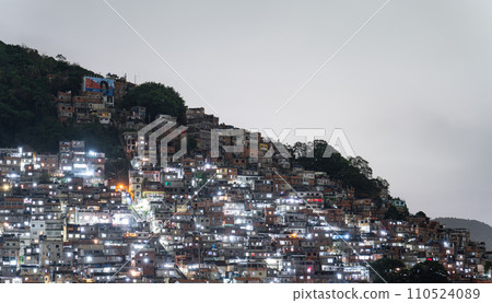Night View of Dense Hillside Favela in Urban Brazil 110524089
